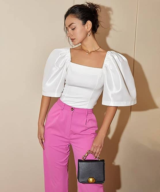model posing in the white blouse with pink pants