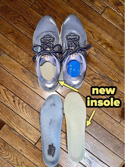  reviewer photo of sneakers with the insole inserted in one shoe and the other insole sitting next to the old, worn out one