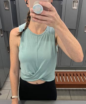 reviewer gym selfie wearing the top in turquoise