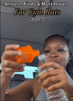 reviewer pouring a supplement from an orange shaker into a water bottle 