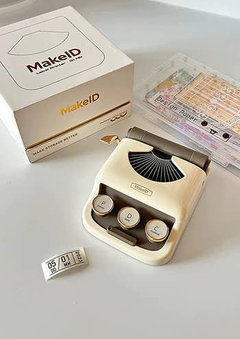 a reviewer showing the ivory label maker with label and packaging