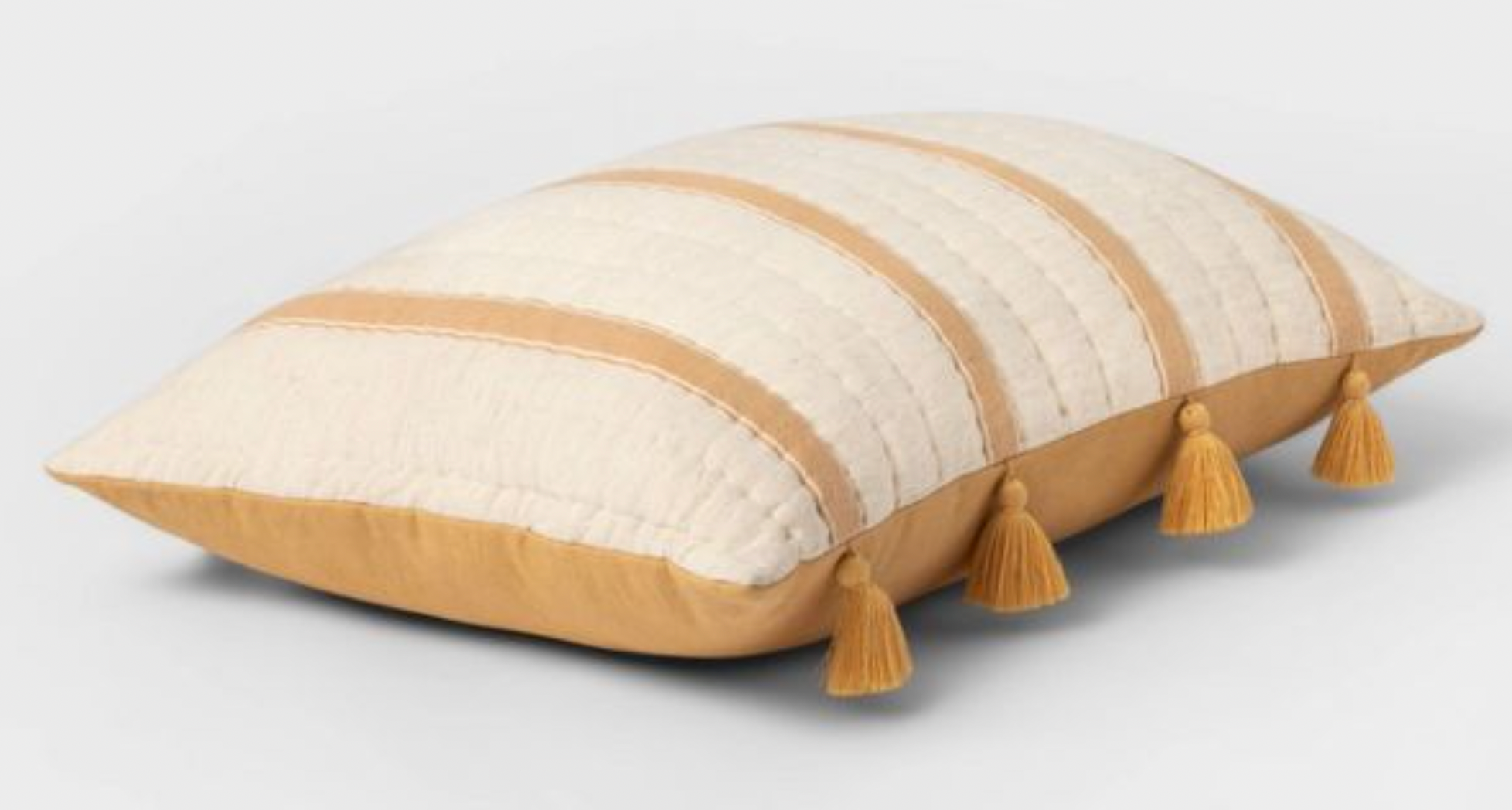 a yellow and beige striped throw pillow with tassles