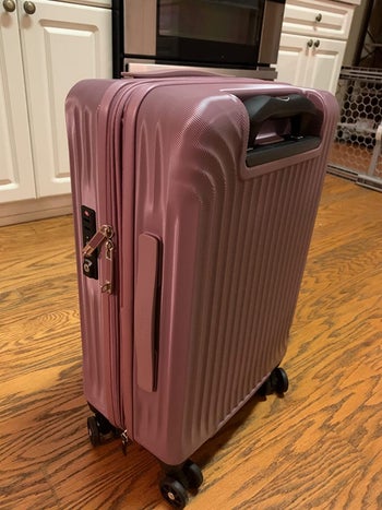 reviewer photo of pink suitcase