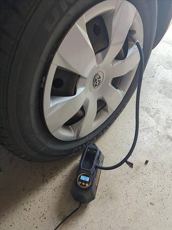 a reviewer phot of the tire inflator with the hose attached to the tire