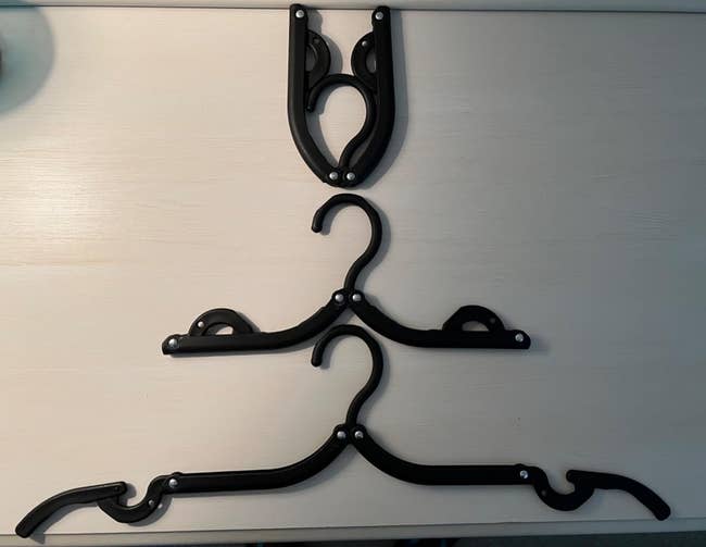 Three folding hangers successful antithetic stages of unfolding