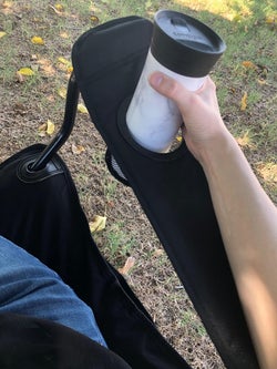 reviewer photo of them using the cupholder in the black camping chair