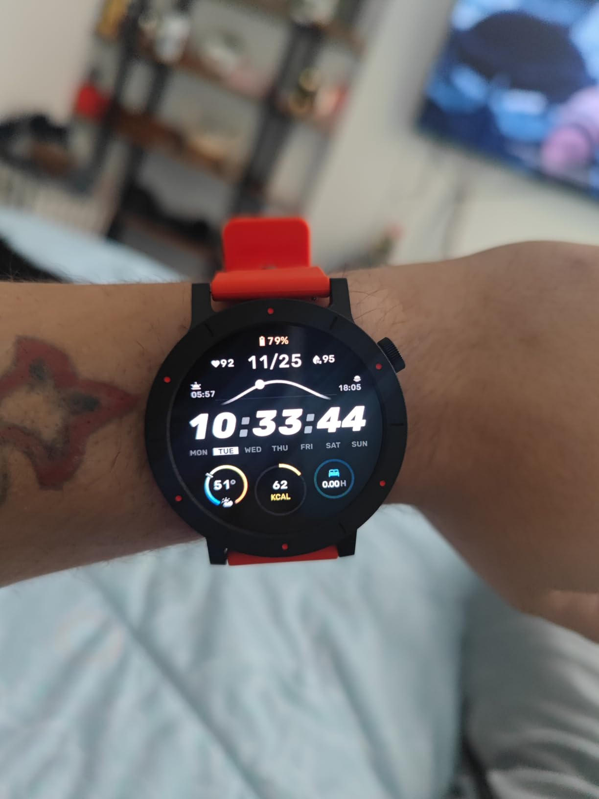 reviewer wearing the ticker  successful  reddish  with the clip  and different   stats visible