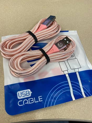 a reviewer's image of two pink braided charger cables