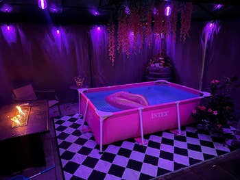 a reviewer's backyard with the pink pool and lights