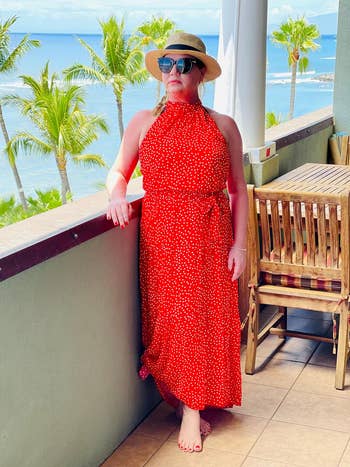 reviewer wearing the dress in red with white polka dots