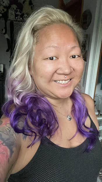 Reviewer's wavy blonde/purple hair after using the heatless curling rod