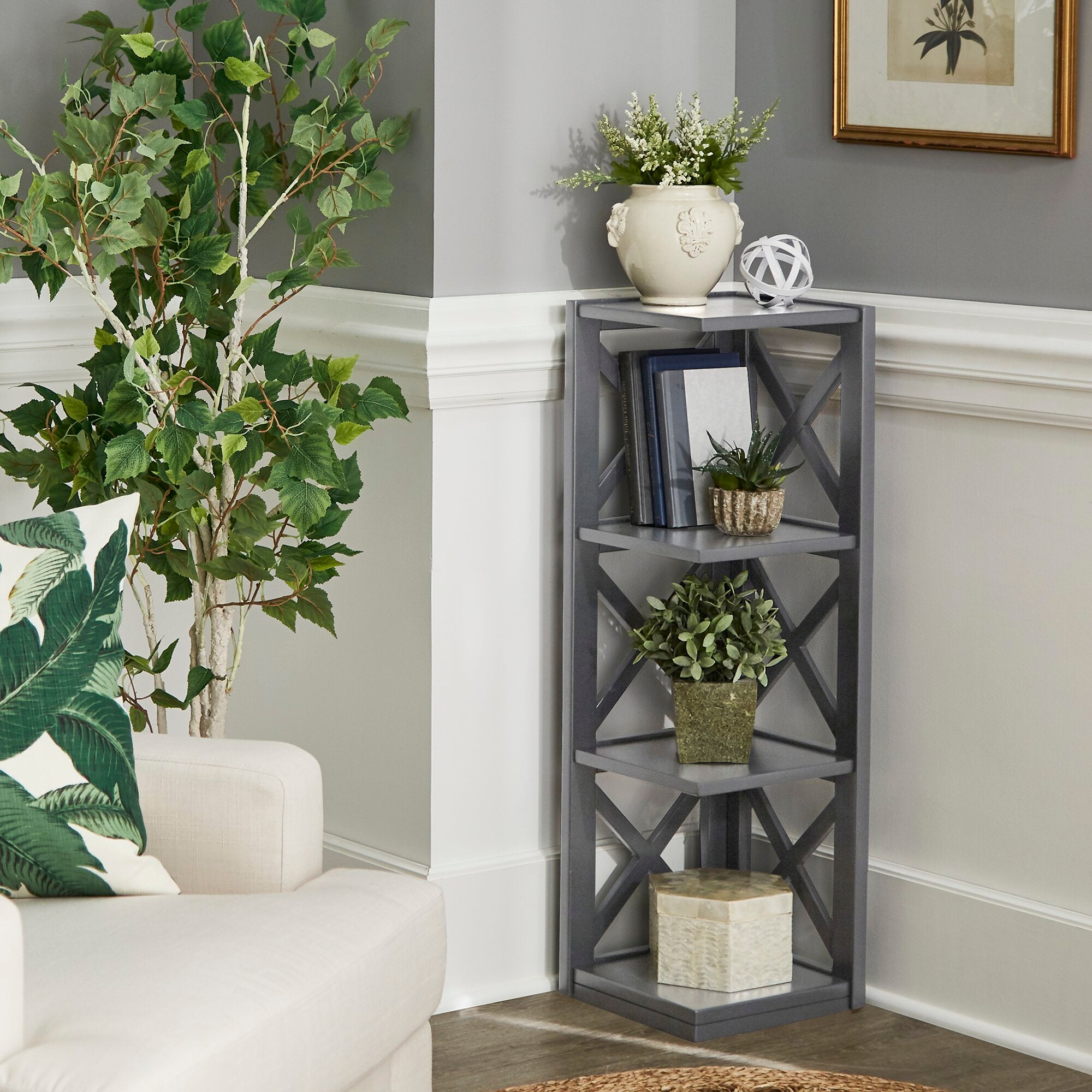 Gray four-tier corner book shelf with X's along the side and plants and books on display