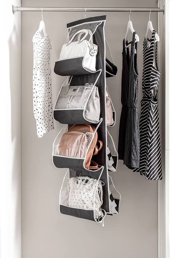 black and clear hanging purse organizer with different-sized crossbody bags in closet