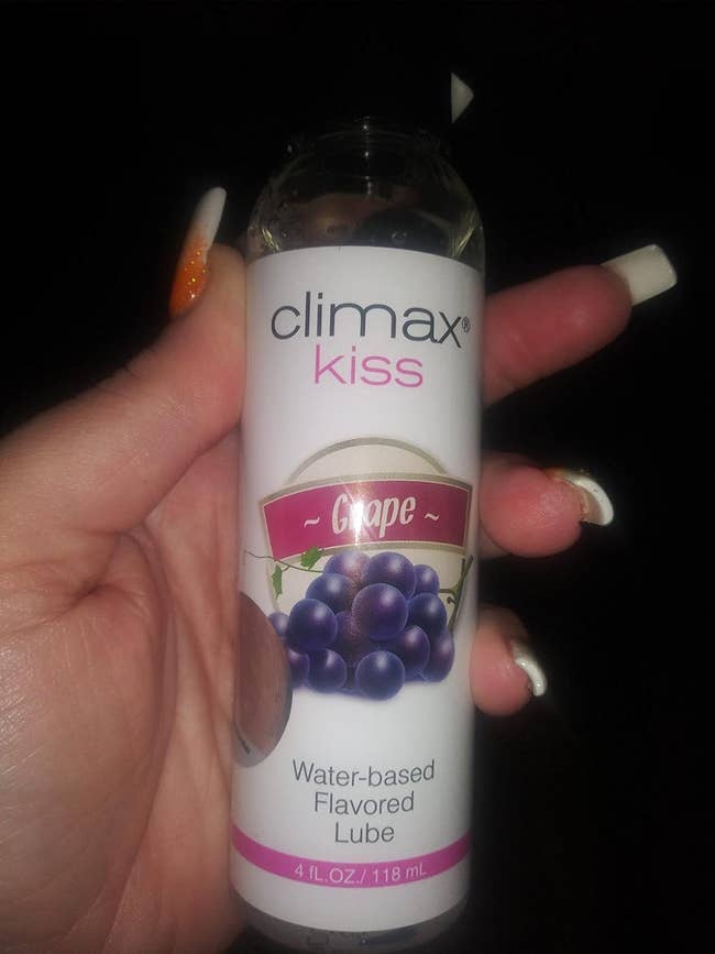 reviewer holding grape-flavored lubricant