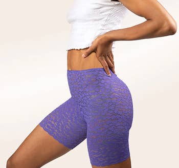 A model wearing the shorts in purple