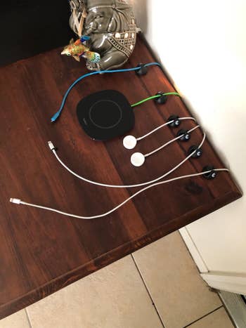 black cable organizers with neat cables placed in them on a wooden desk