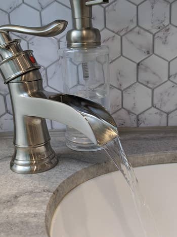 the faucet successful metallic with a watercourse of h2o pouring out