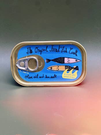Canned fish product with illustrated fish and text, 