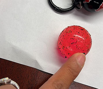 reviewer pointing to the dirt the ball has collected from their bag