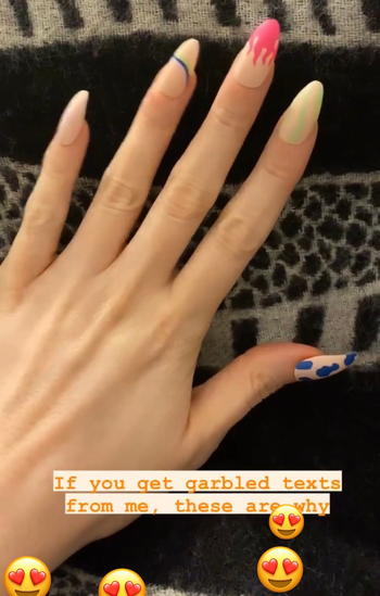 hand with long faux nails