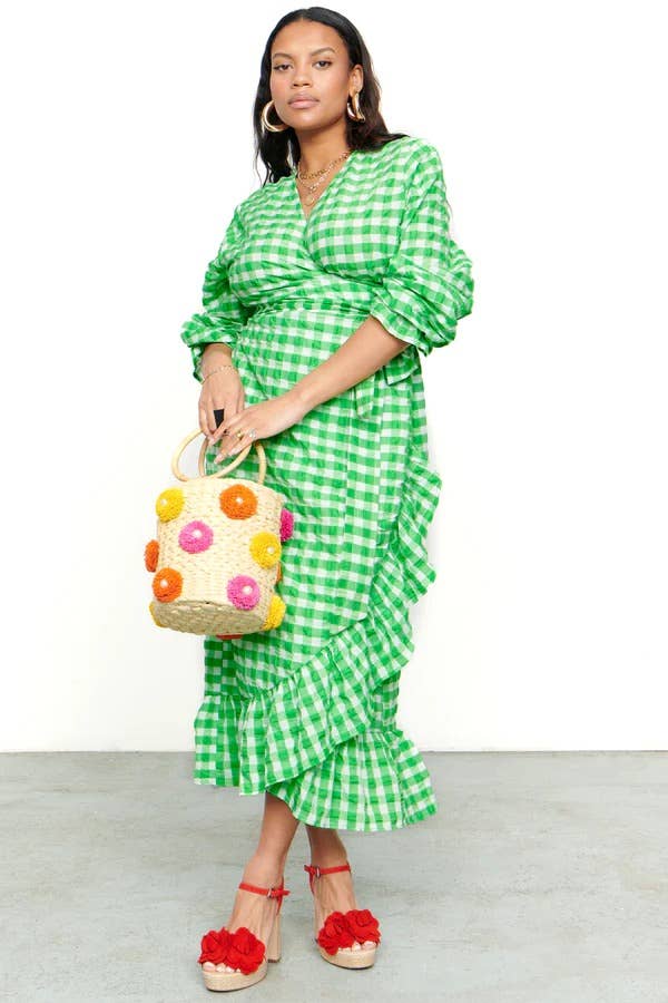 model wearing the green checkered wrap dress