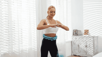 Model the usage of a blue weighted hoop to swing into a exercise 