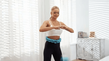 Model using a blue weighted hoop to swing into a workout 