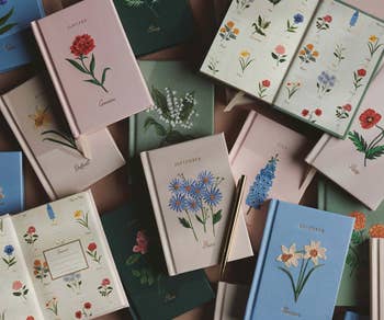 Journals with floral covers arranged successful  a flatlay, each   with a period  connected  the cover, suggesting a monthly planner oregon  diary theme