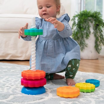 Child playing with colorful ring toy