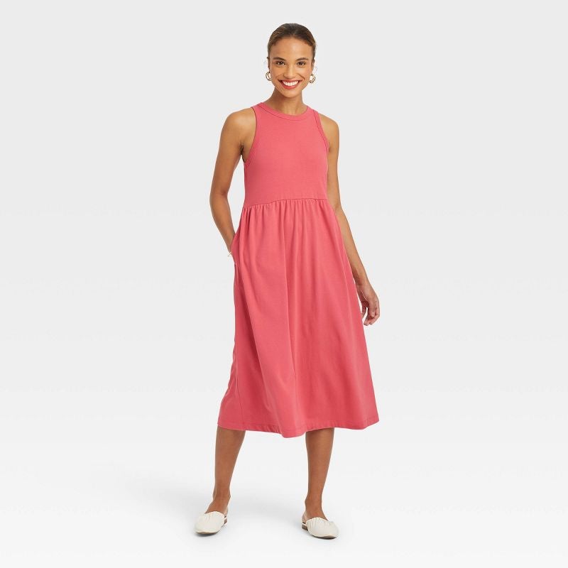 model wearing pink ballet style dress with white shoes