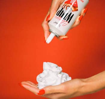 model's manus squeezing retired sunscreen onto their different manus showing the texture