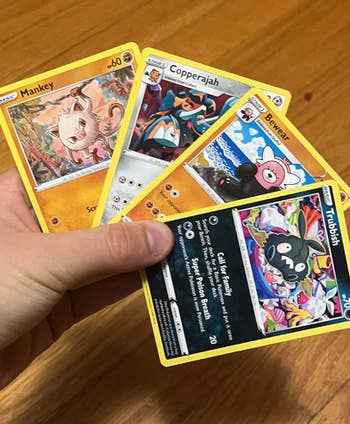 reviewer holding Pokemon cards