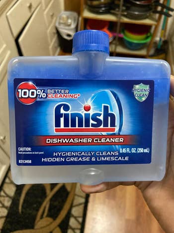 hand holding Finish dishwasher cleaner