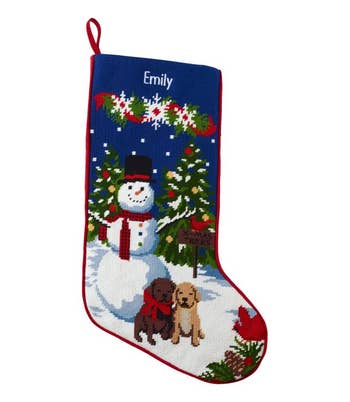 an l.l. bean needlepoint stocking with a snowman and two puppies on it