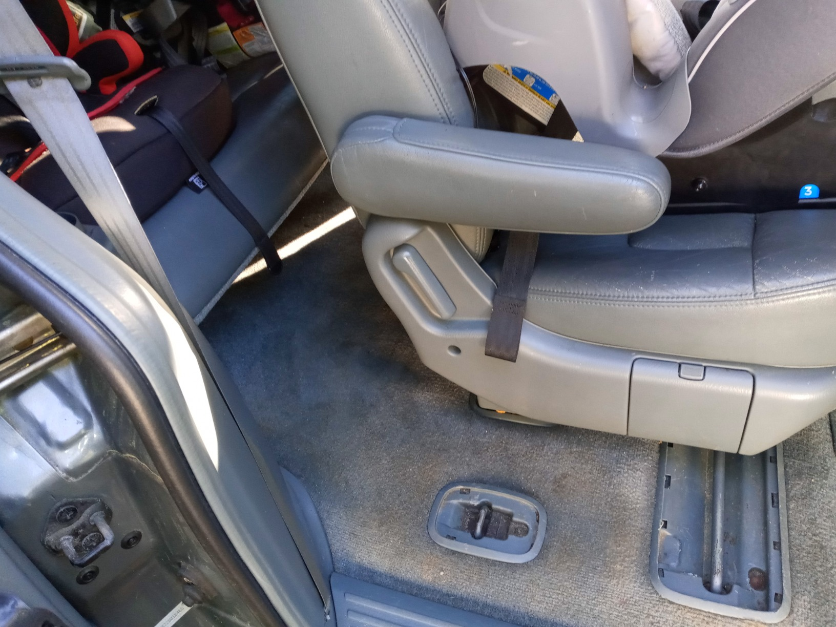 Vehicle interior with a grey  car   spot   installed successful  the 2nd  enactment      facing rear. Carpeted level  with disposable   spot   anchor points