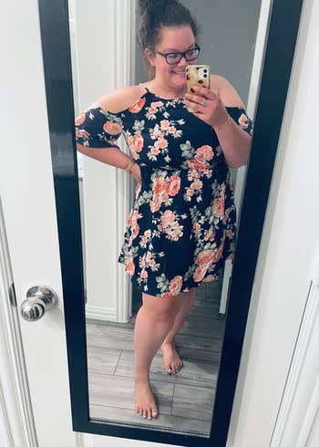 reviewer wearing the dress in navy with pink floral print