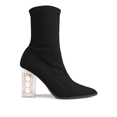 a black bootie with a pearl heel