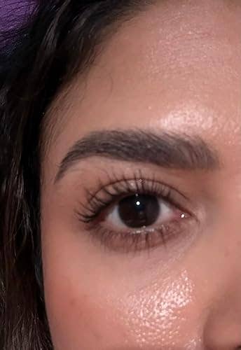 Close-up of a person's oculus showcasing neatly groomed eyebrows and agelong eyelashes, suitable for quality merchandise promotion
