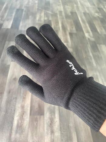 the backside of a reviewer's hand wearing the glove 