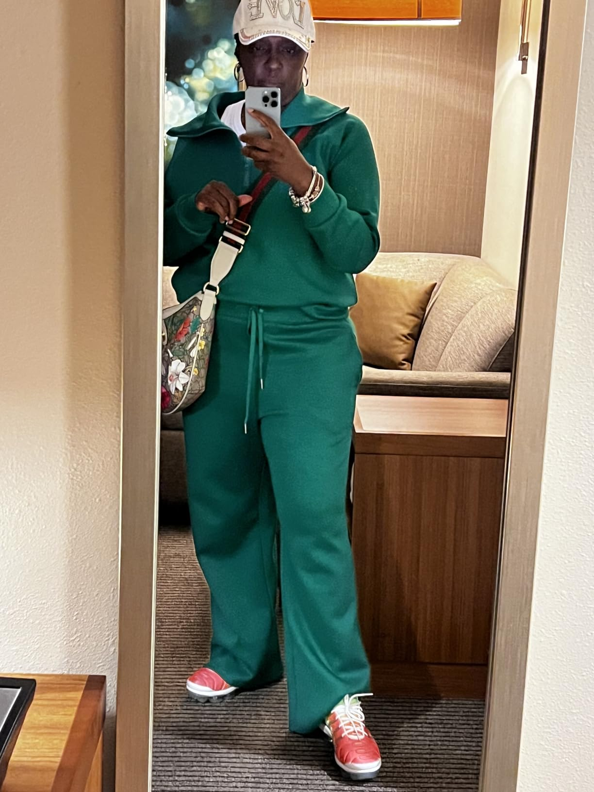 Person successful  a stylish loungewear acceptable   and headdress  taking a reflector  selfie, holding a decorator  bag, showing a casual and trendy look