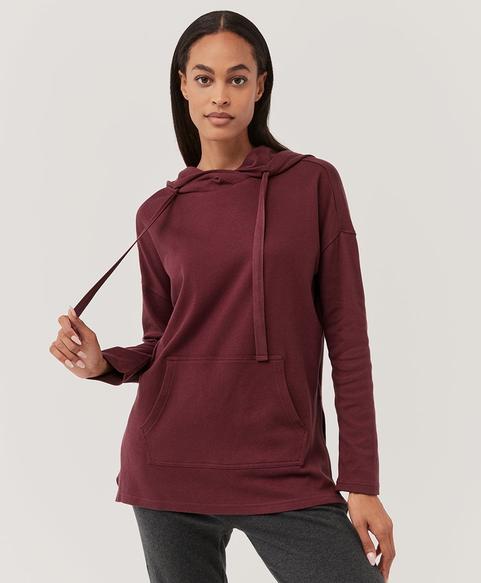 model wearing the thin hoodie in red