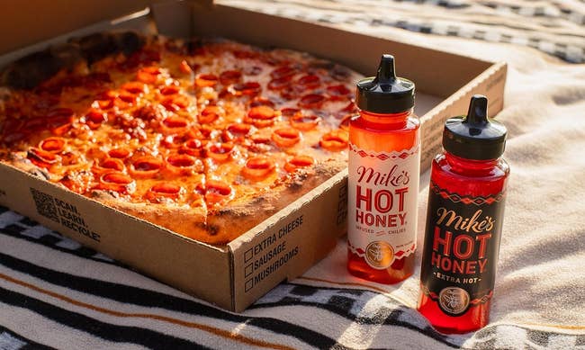 bottles of mike's hot honey next to a box of pepperoni