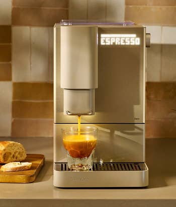 espresso instrumentality pouring espresso into a cupful with glowing