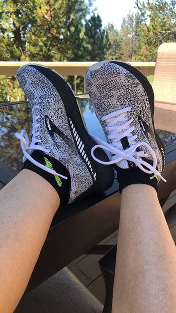 close-up of reviewer wearing the grey and black running sneakers