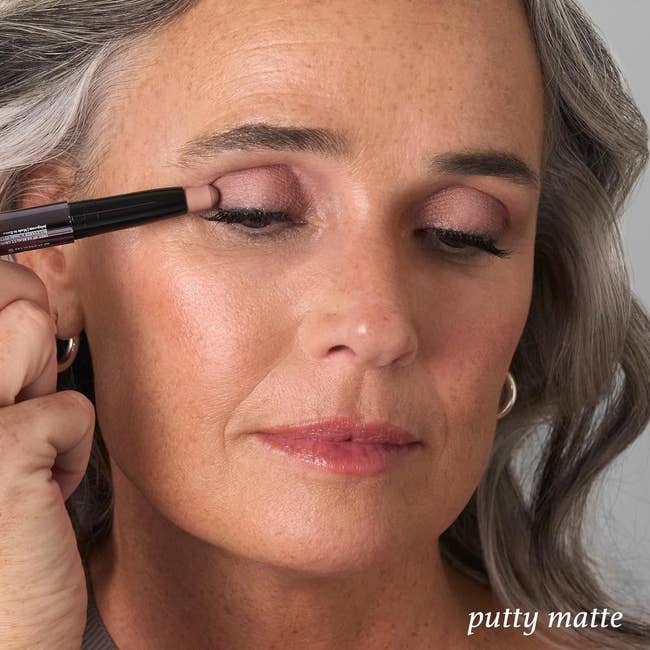 a model applying the eyeshadow stick