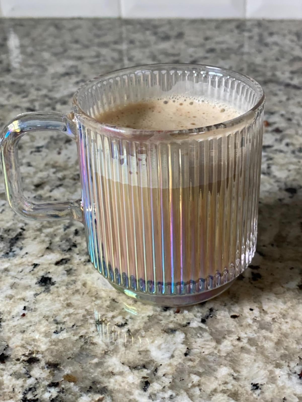 an iridescent striped glass mug
