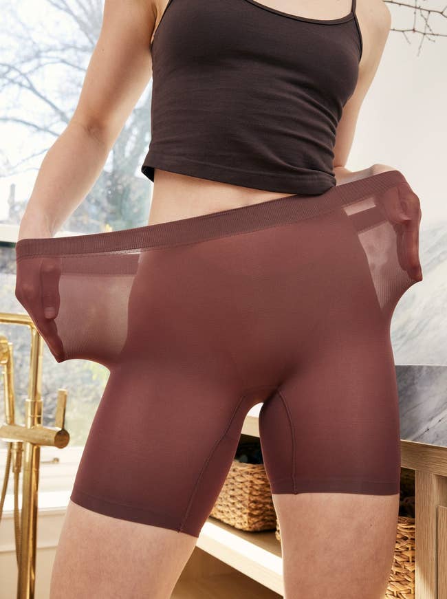 model wearing the sheer shorts in brown