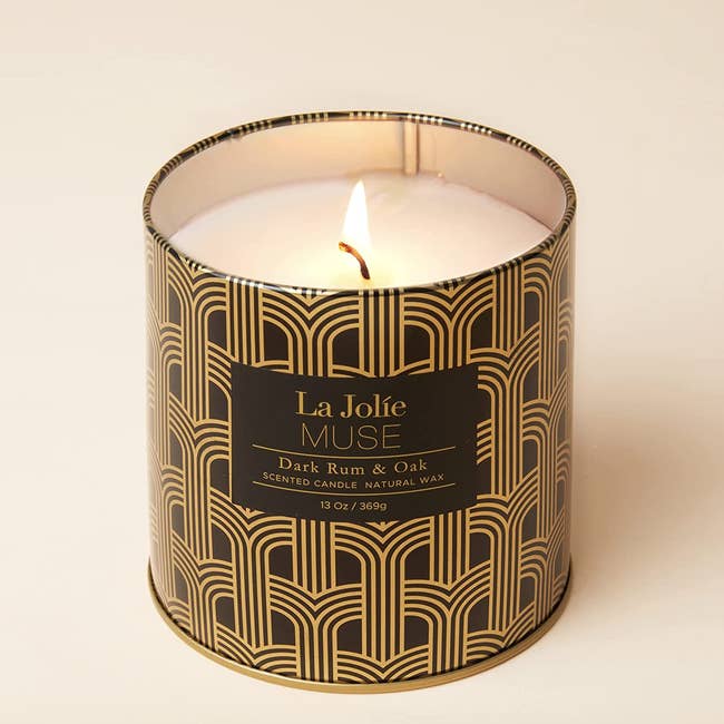 a black and gold printed tin candle 