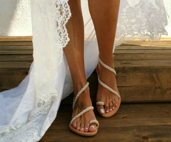 model wearing the leather sandals with a wedding dress