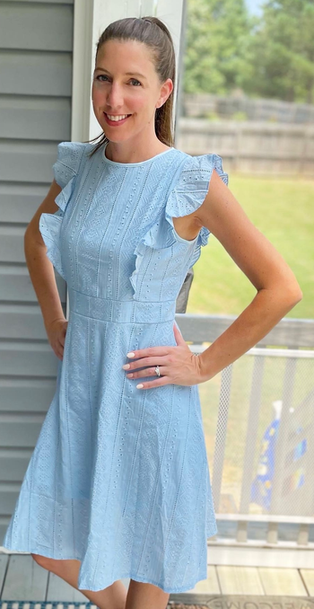 a reviewer wearing the light blue dress